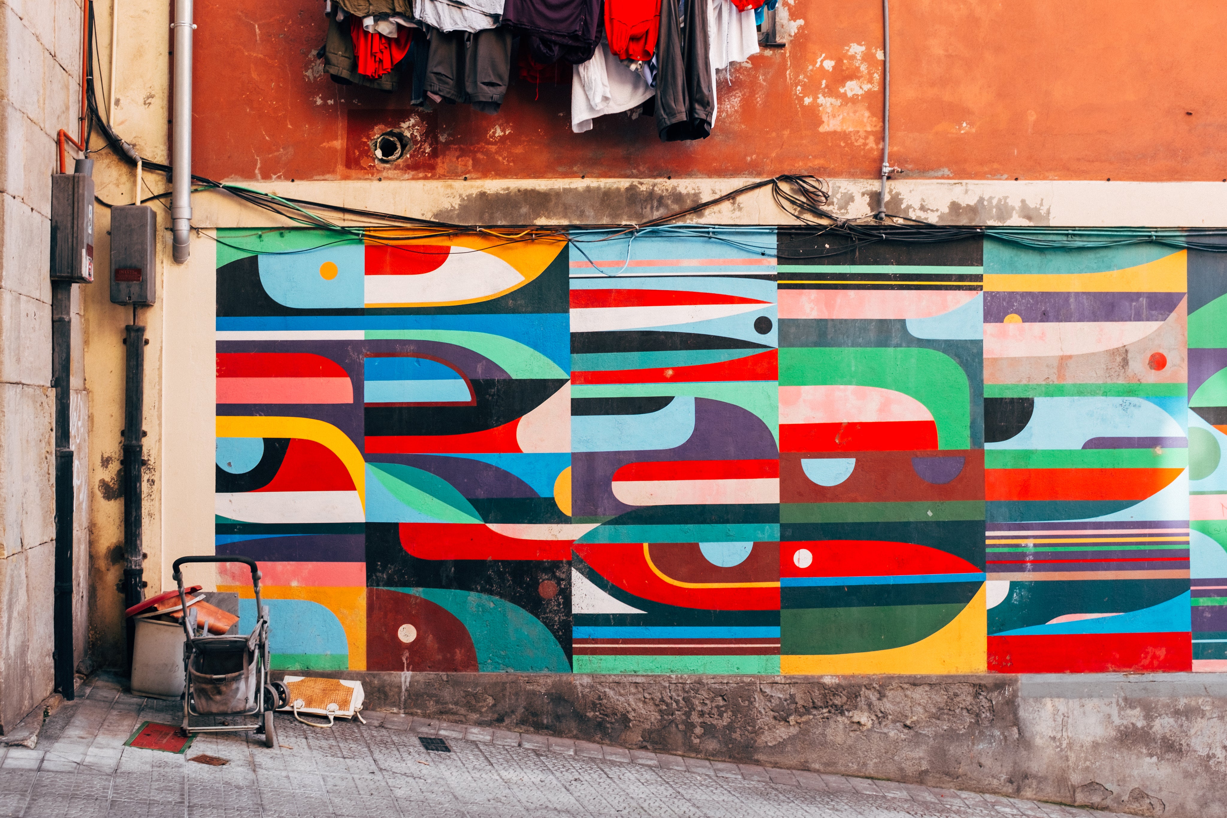 colorful-geometric-wall-art-on-a-shabby-street - PrettyKase
